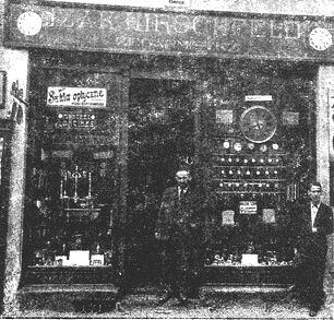san226.jpg [34 KB] - Reb Yitzchok Hirschfeld in front of his watch making and jewelry store and workshop