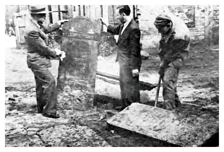 zgi775.jpg Re-erecting gravestones in the cemetery [12 KB]